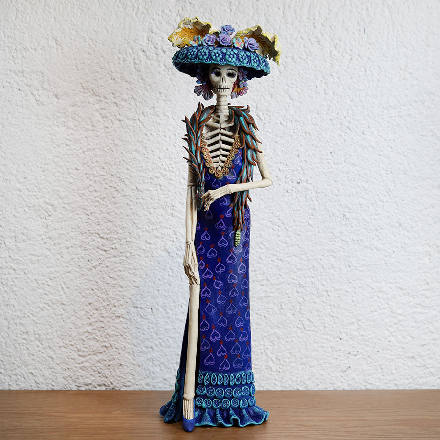 Catrina with a blue dress with hearts made of polychrome clay – Tikal