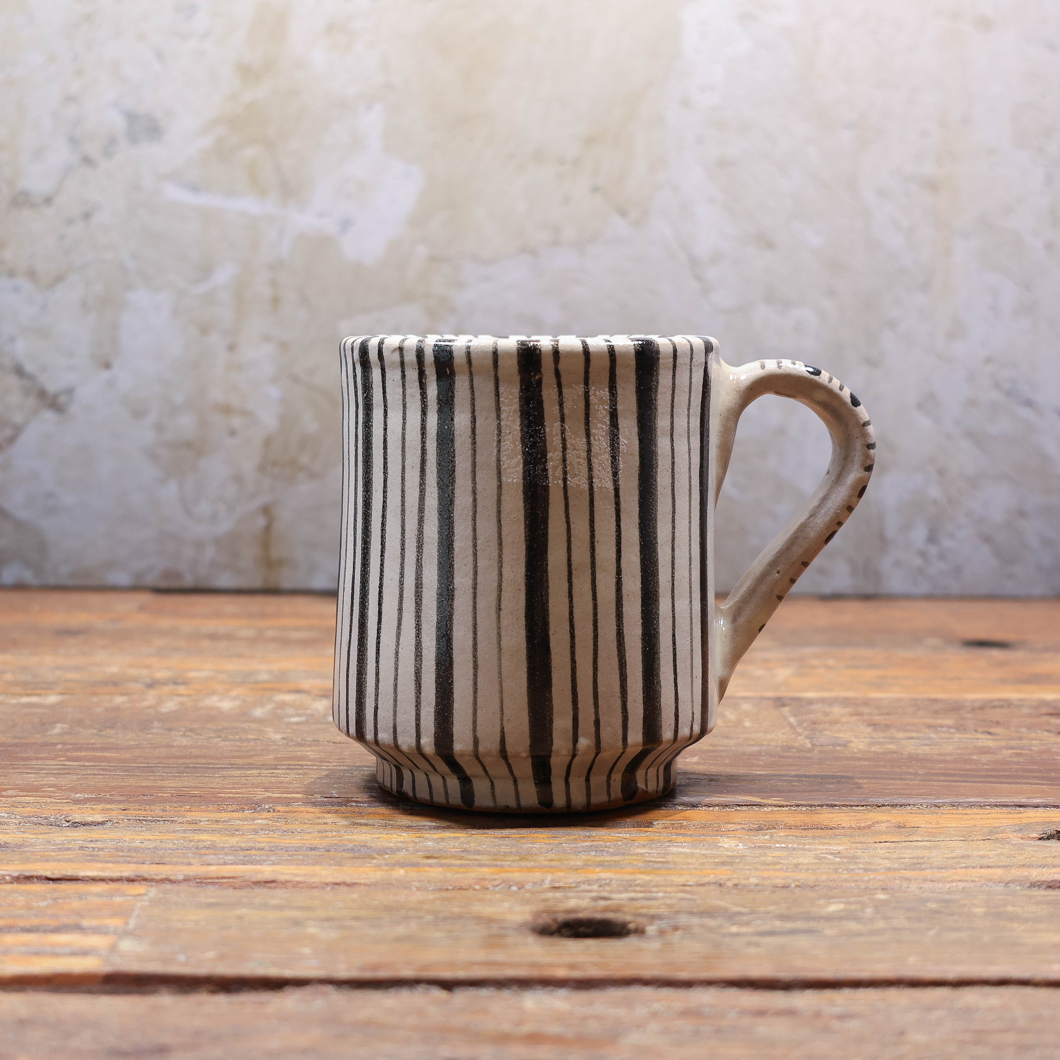 Beige mug with black stripes