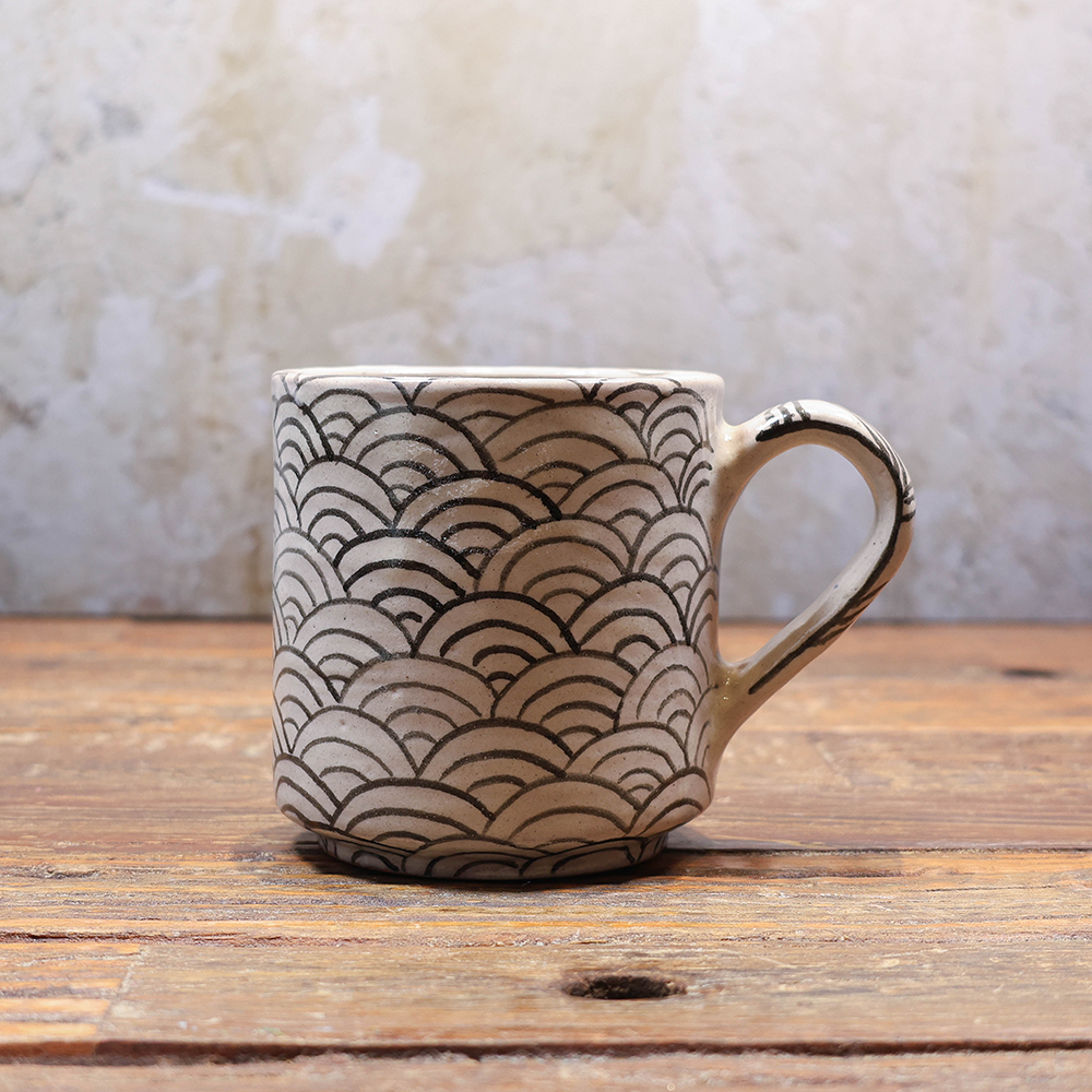 Beige mug with black waves