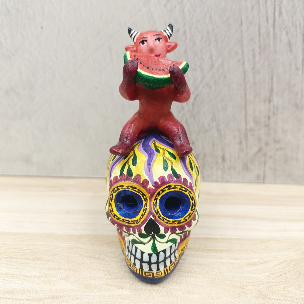 Clay skull with devil and watermelon