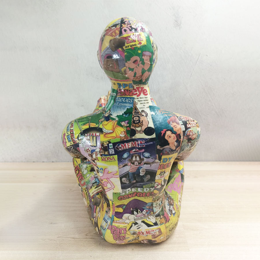 Adam sentado con libro forrado con historietas chico