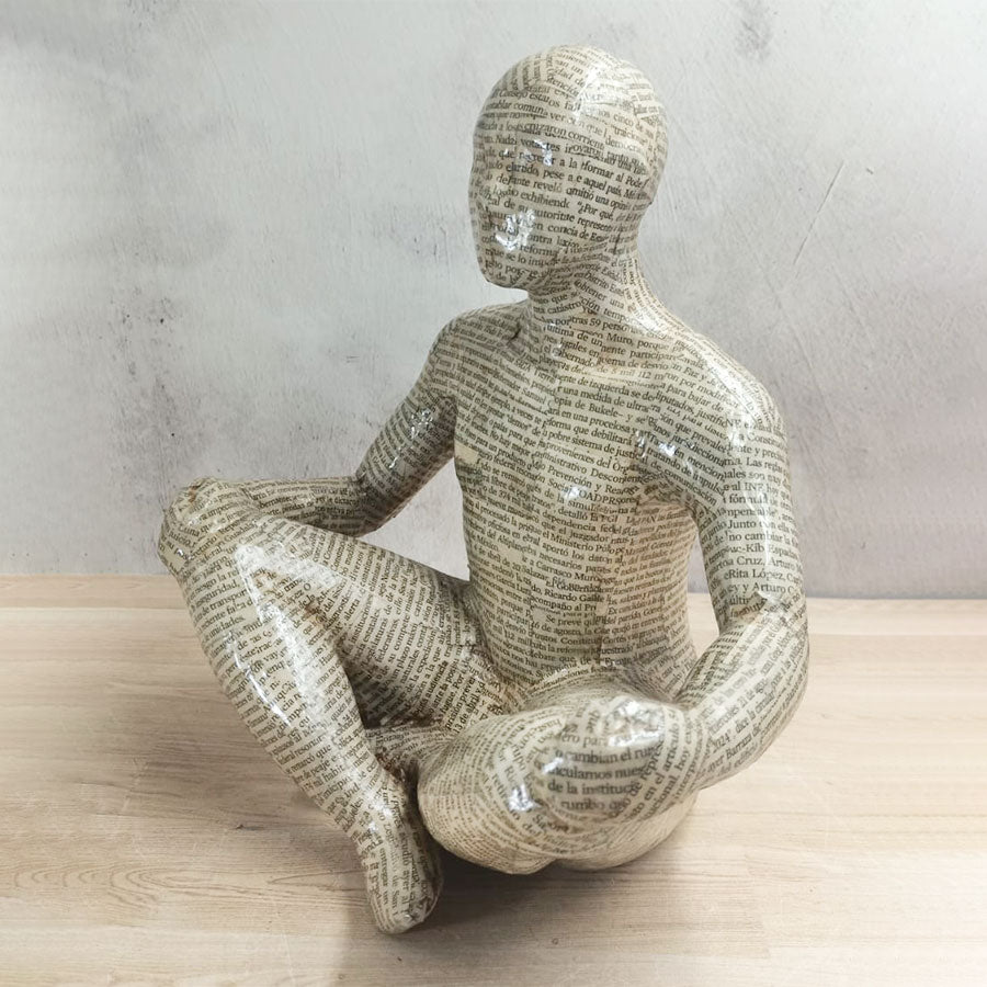 Adam covered with newspaper style sheets