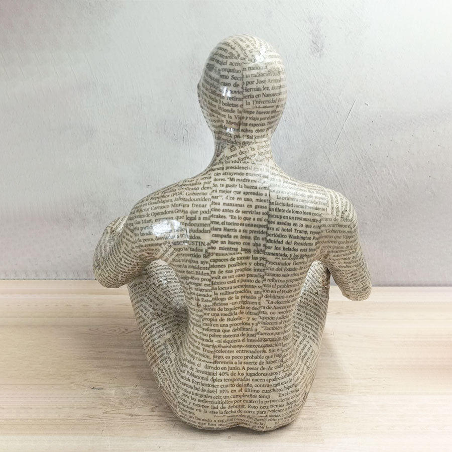 Adam covered with newspaper style sheets