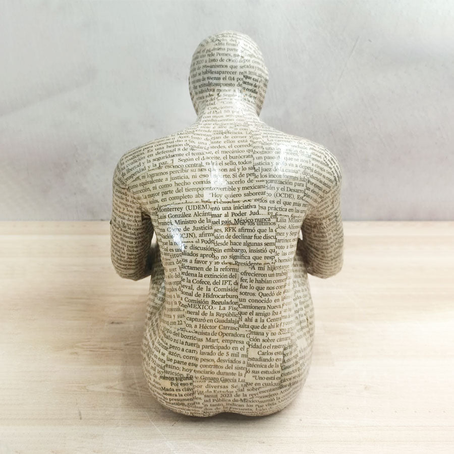 Adam without a book with a newspaper-style cover