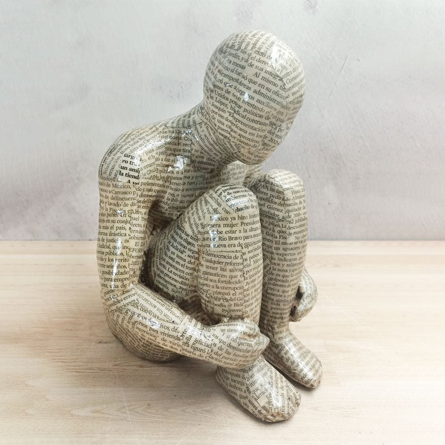 Adam without a book with a newspaper-style cover