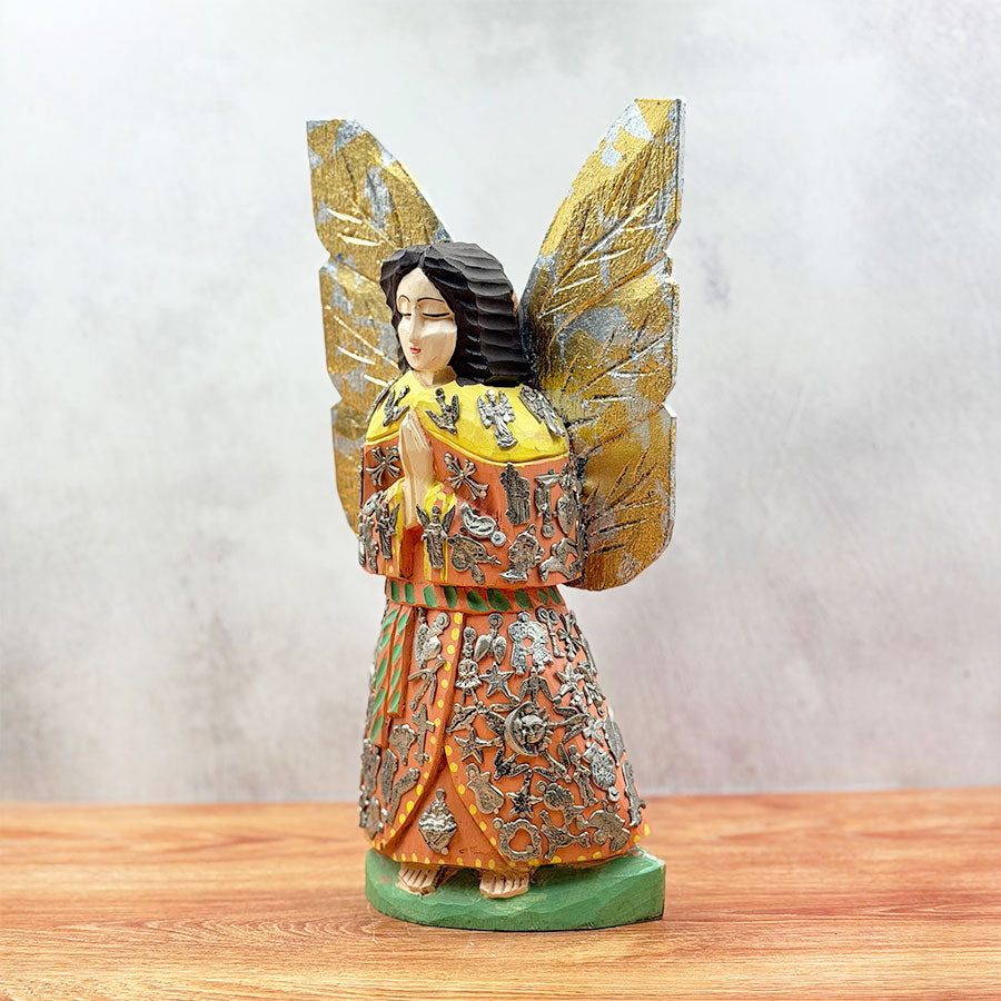 Angel with outstretched wings and "milagritos"