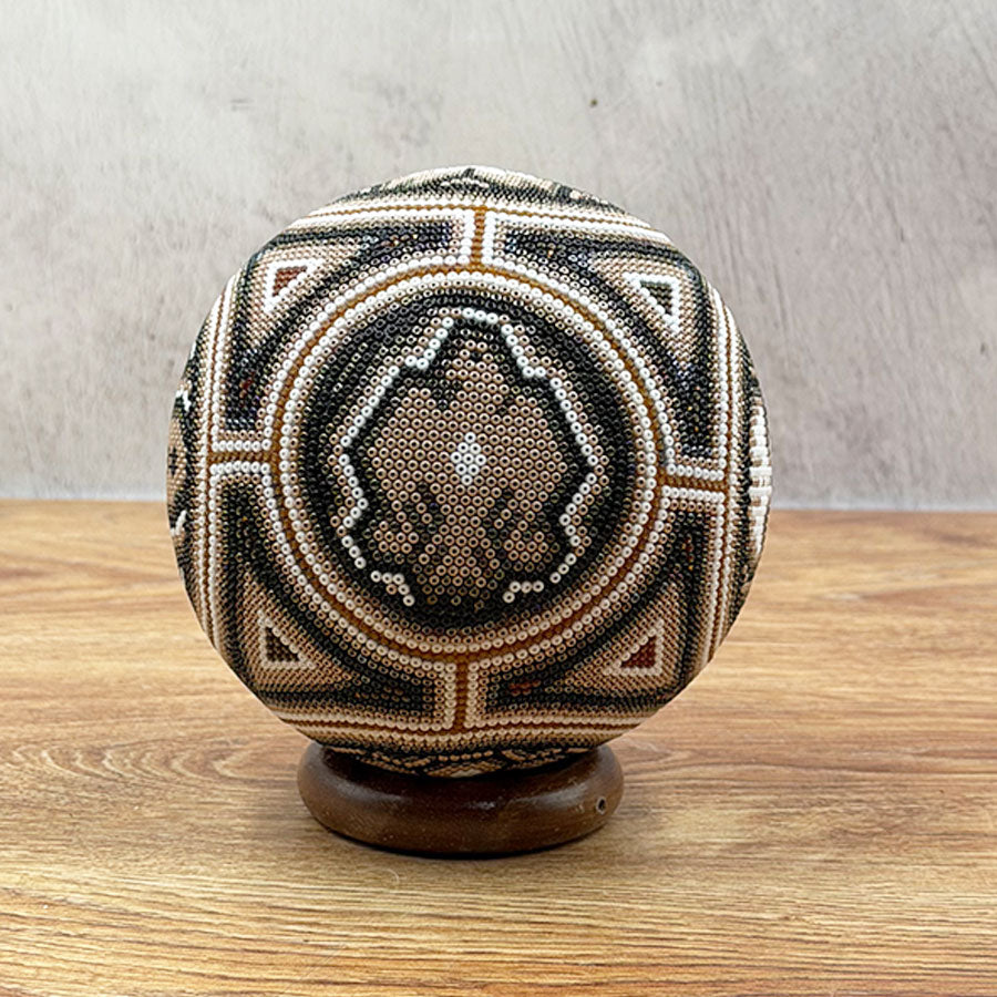 Brown ball with Wixárika design