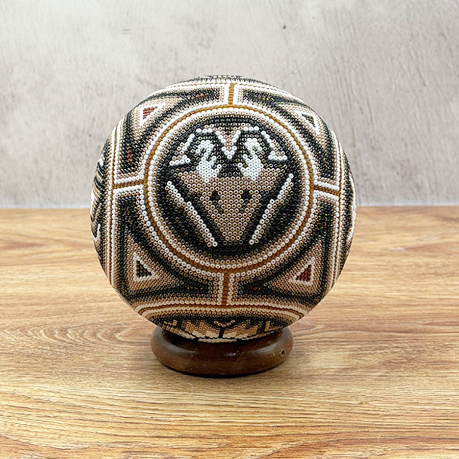 Brown ball with Wixárika design