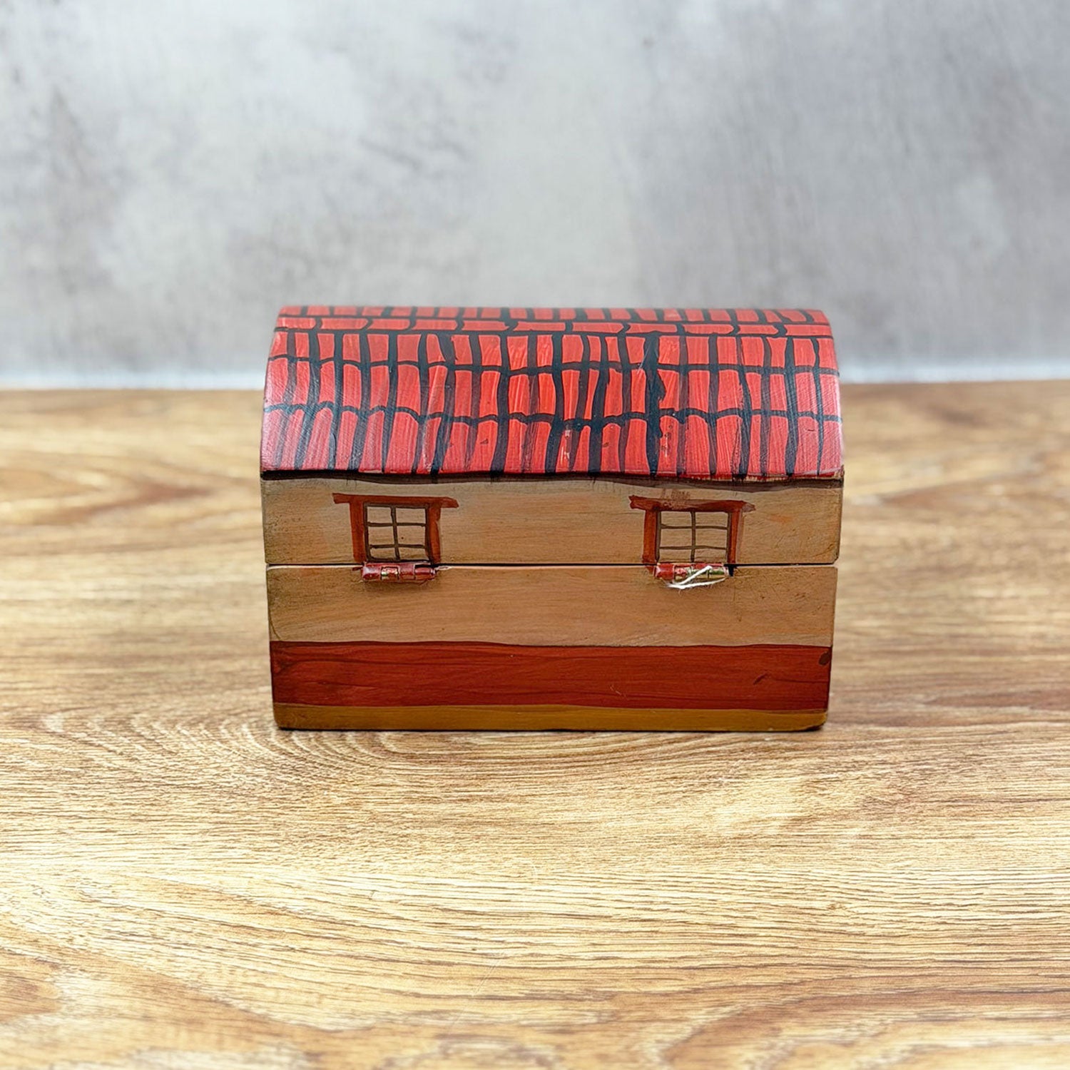 Small chest decorated with a little house design
