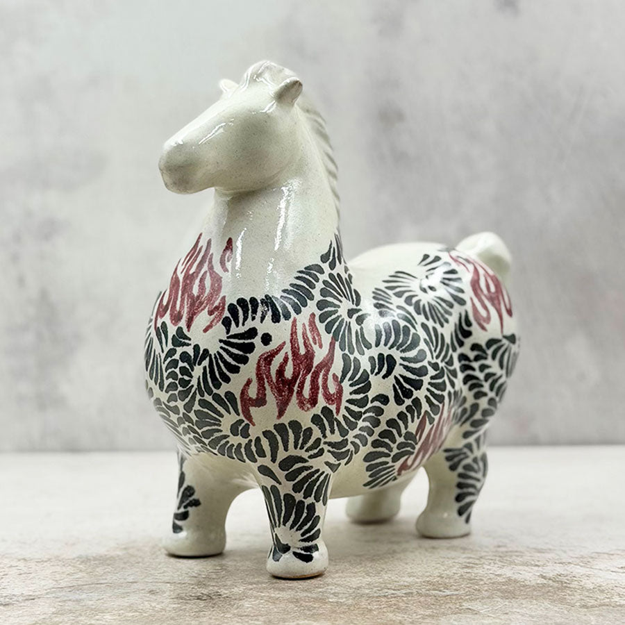 Horse with black and red feathered design