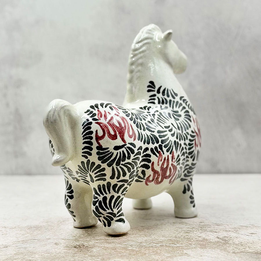 Horse with black and red feathered design