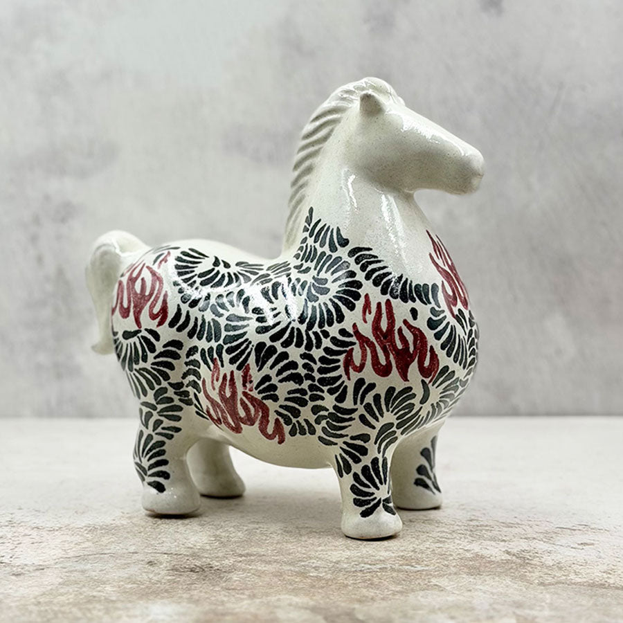 Horse with black and red feathered design