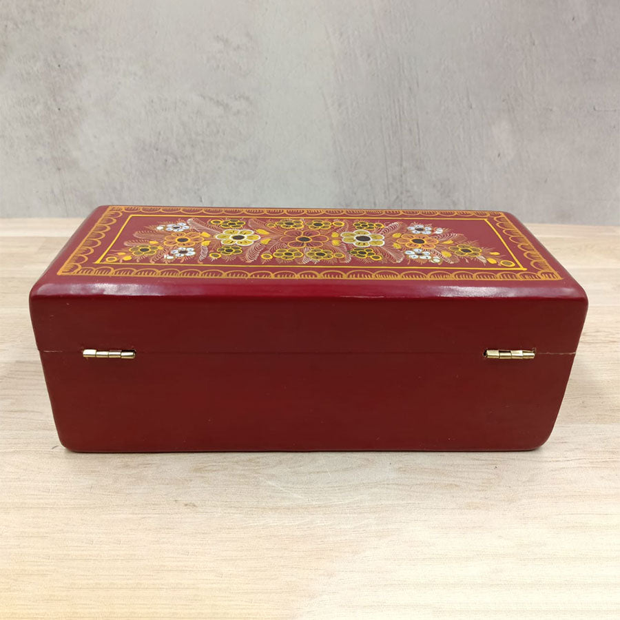 Red wooden box decorated with flowers