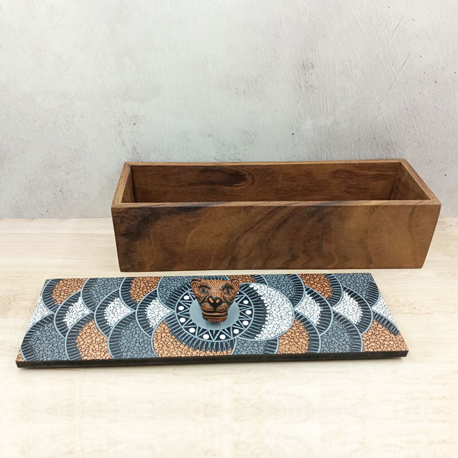 Rectangular box with brown lid with geometric motifs and a jaguar head