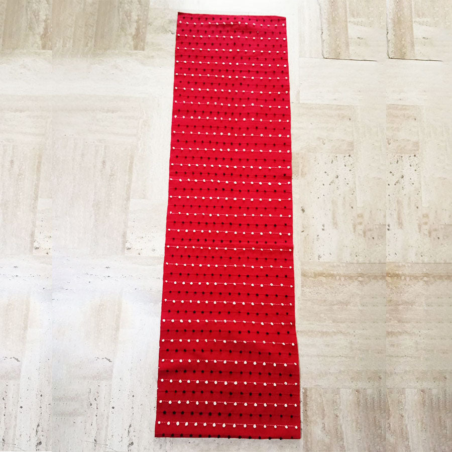 Red table runner with little balls design
