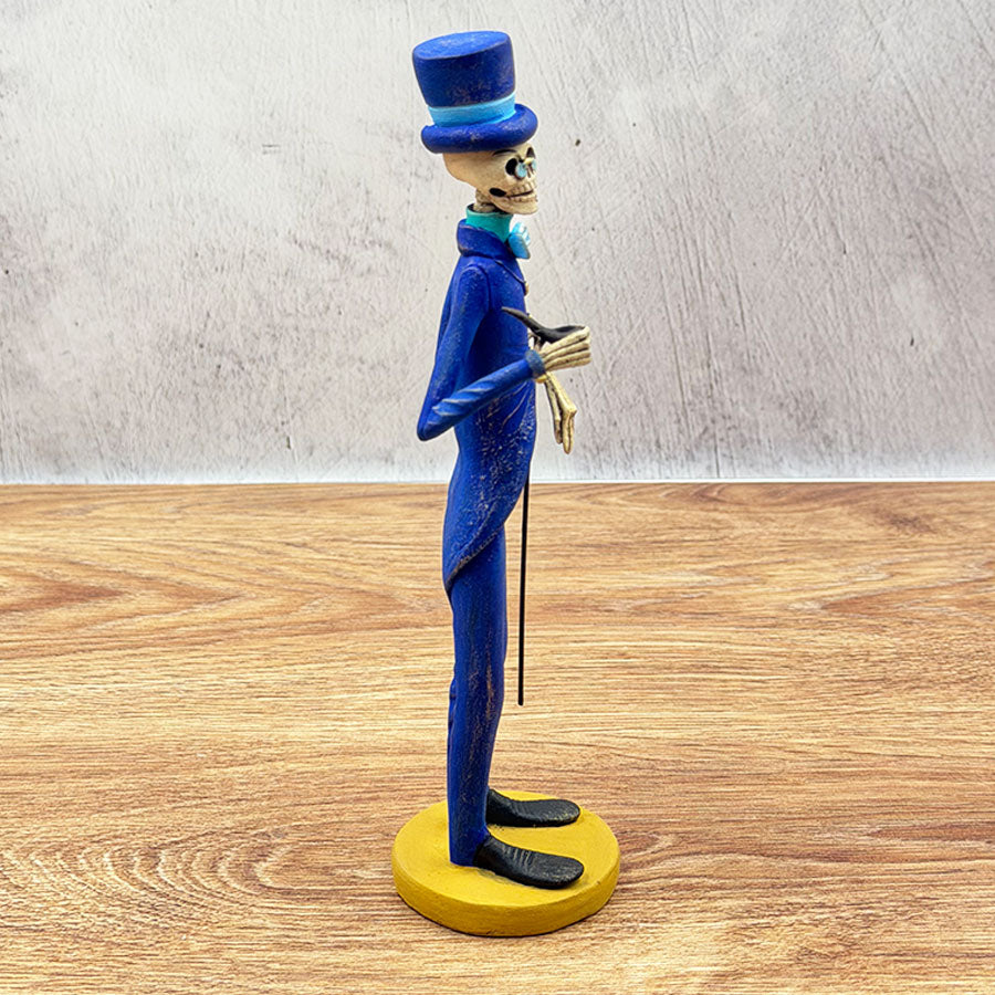 Catrín in a blue suit and cane