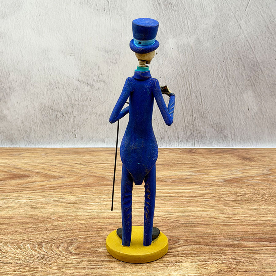 Catrín in a blue suit and cane