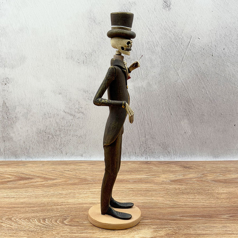 Catrín in a brown and gold suit