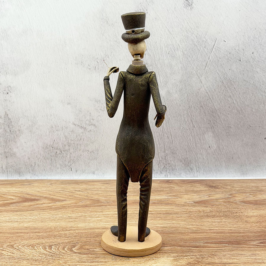 Catrín in a brown and gold suit