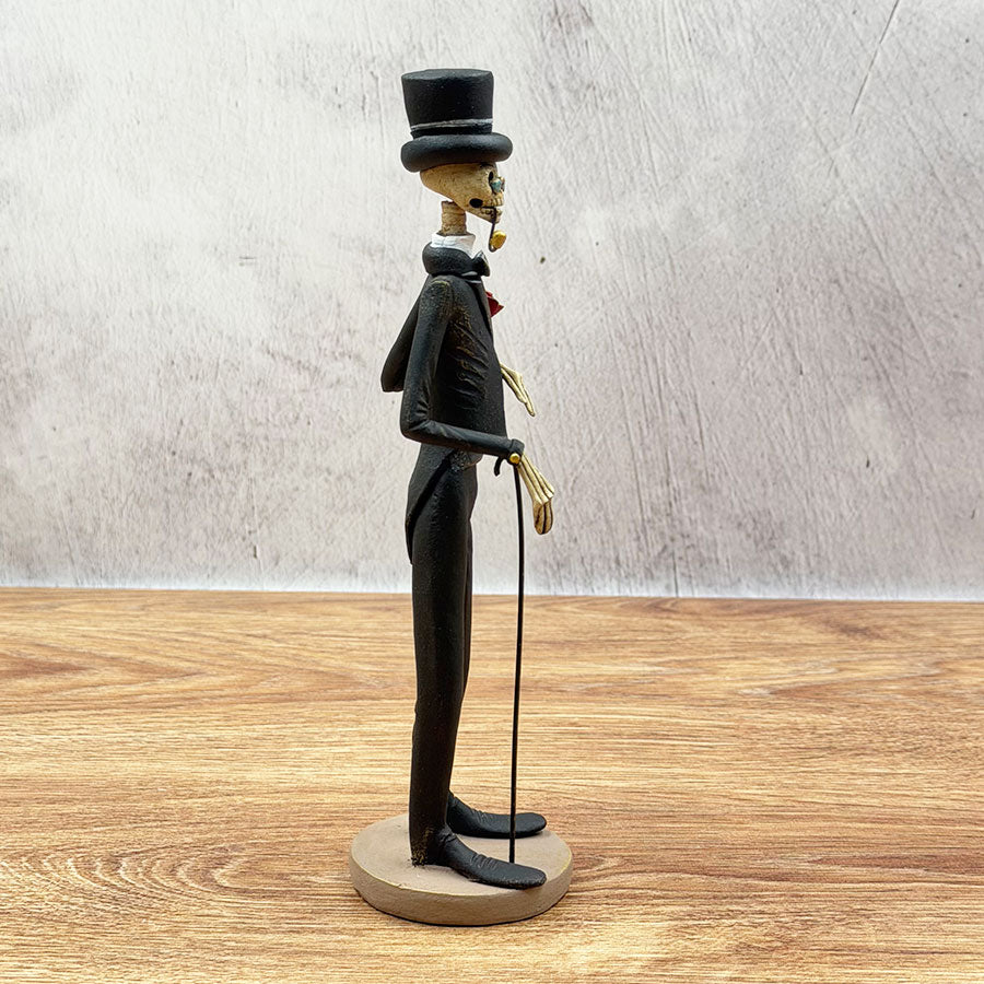 Catrín in a black suit with a cane