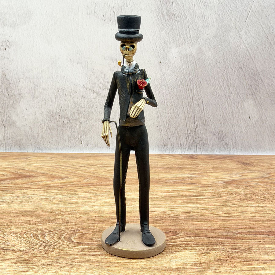 Catrín in a black suit with a cane