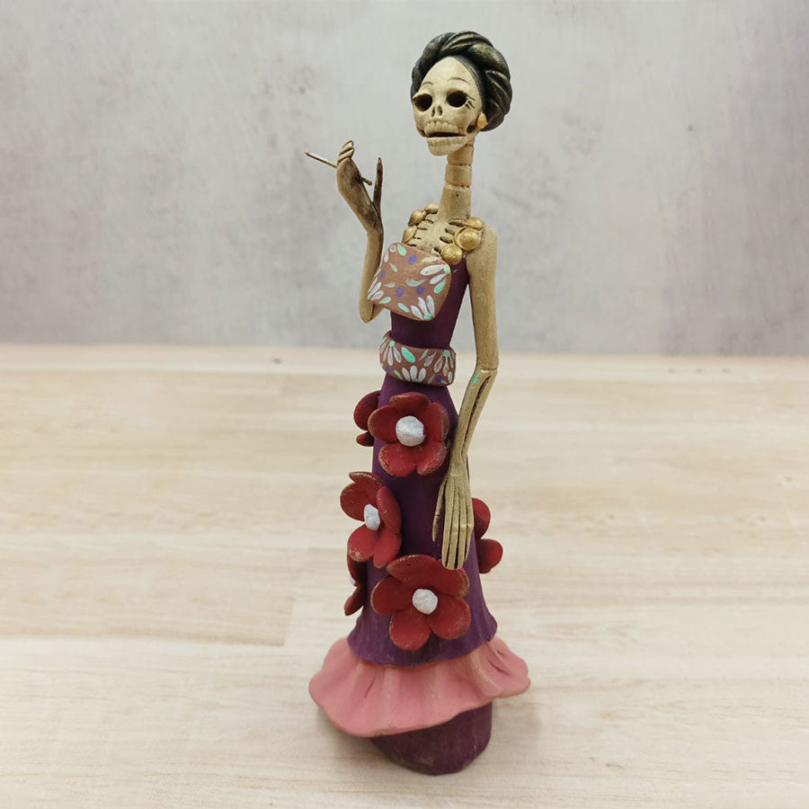 Catrina in purple dress with red flowers