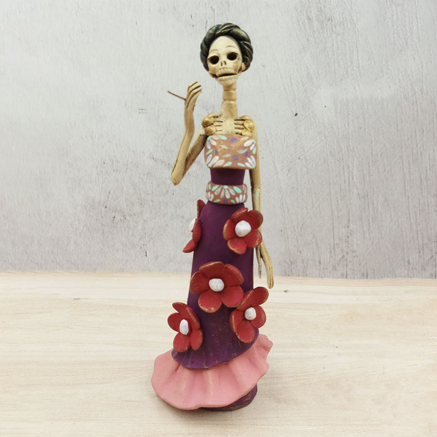 Catrina in purple dress with red flowers