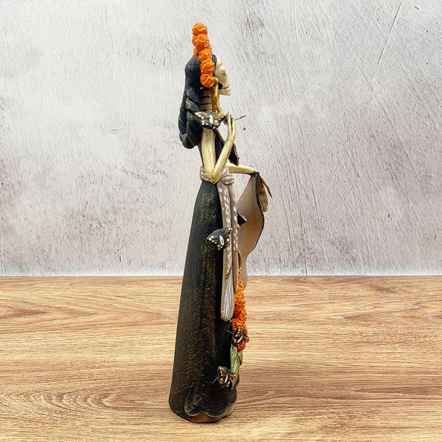 Catrina with black dress and marigold flowers