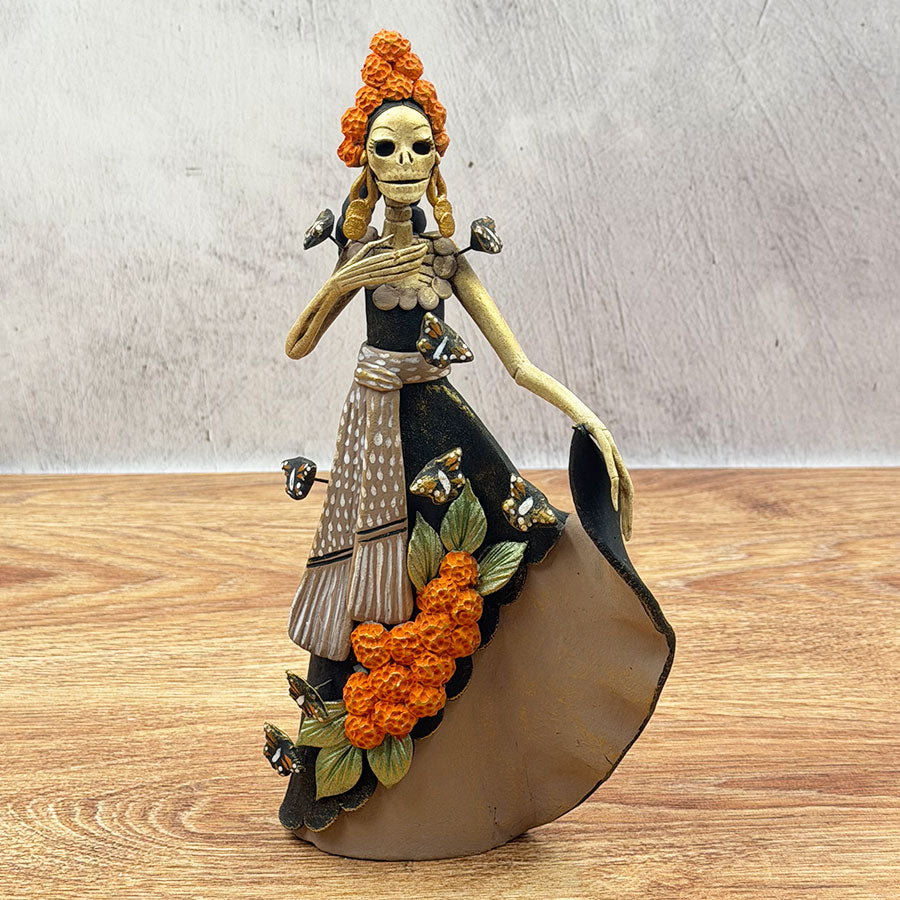 Catrina with black dress and marigold flowers made of polychrome clay ...