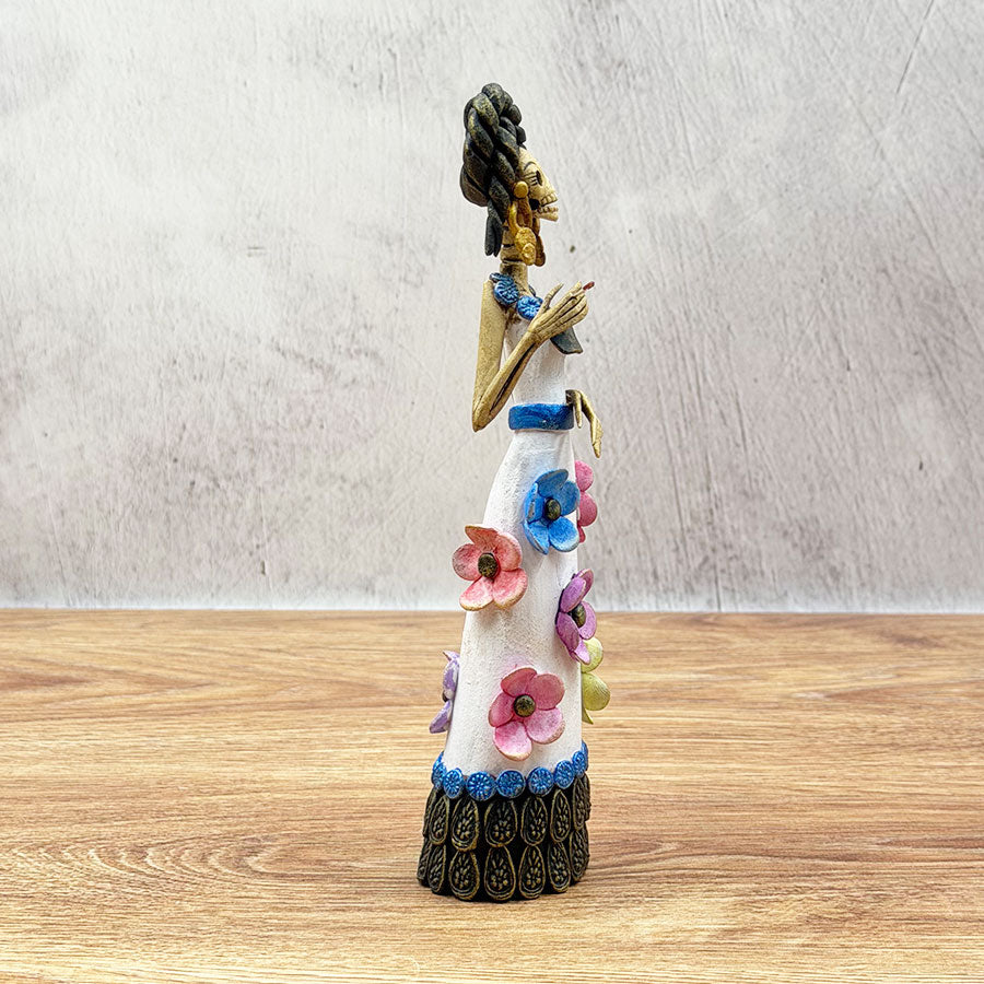 Catrina wearing a white dress with colorful flowers