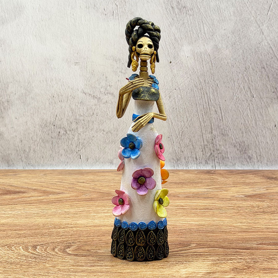 Catrina wearing a white dress with colorful flowers