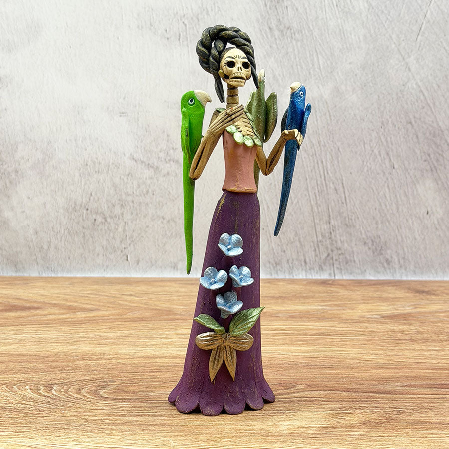 Catrina with a purple dress and macaws