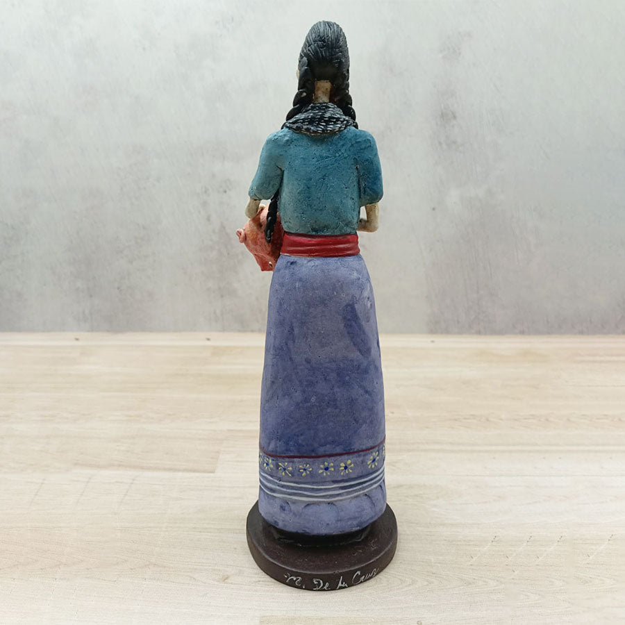 Catrina with a purple skirt and a pig