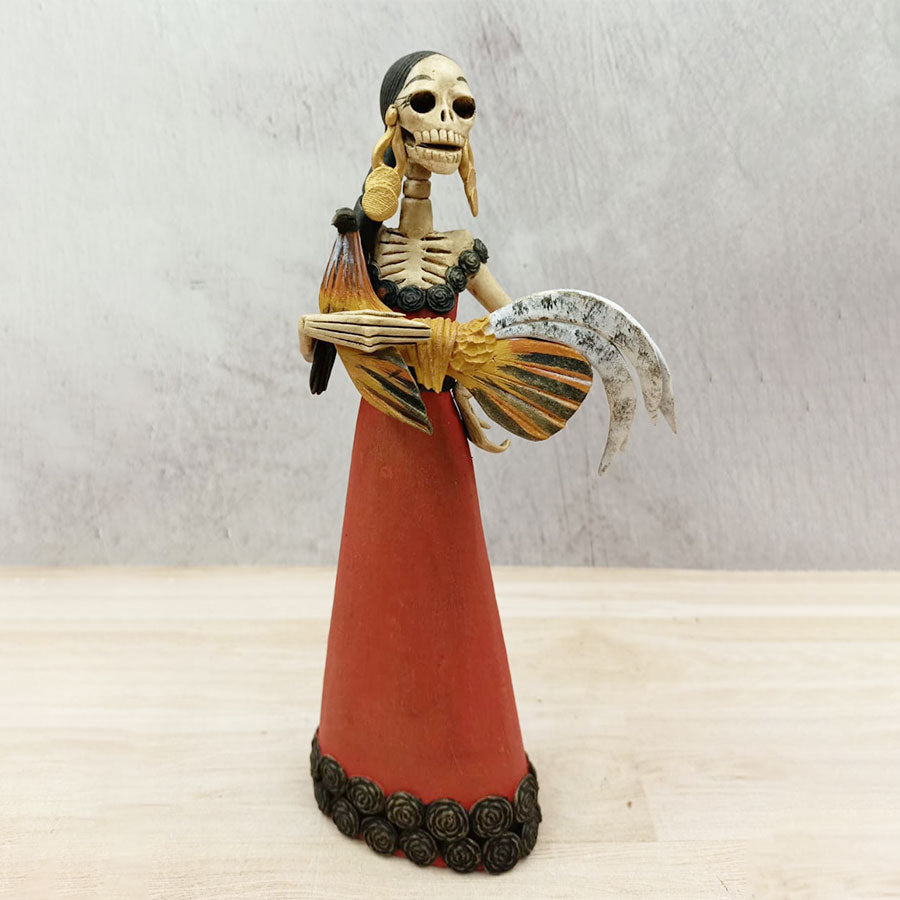 Catrina in red dress with a rooster