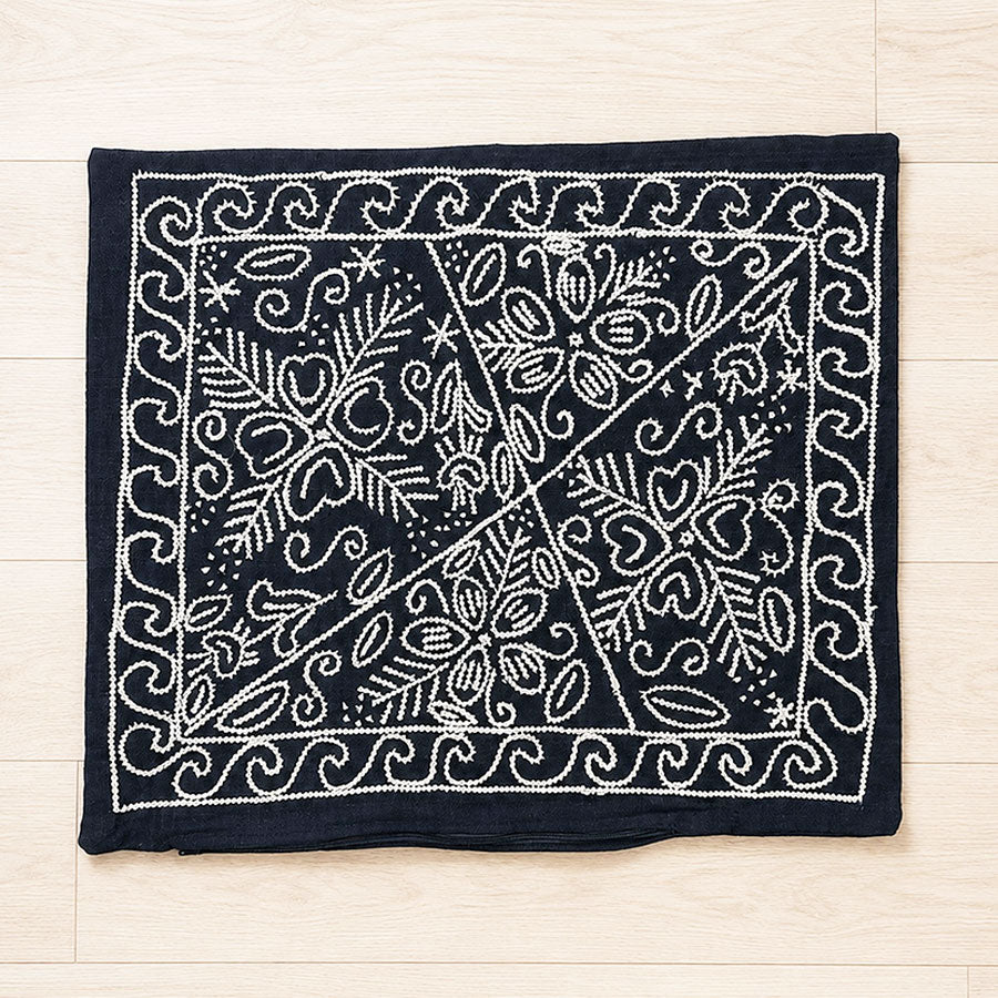 Black cushion cover with embroidered white flowers