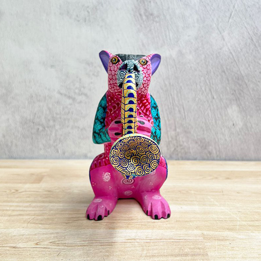 Pink alebrije rabbit with saxophone