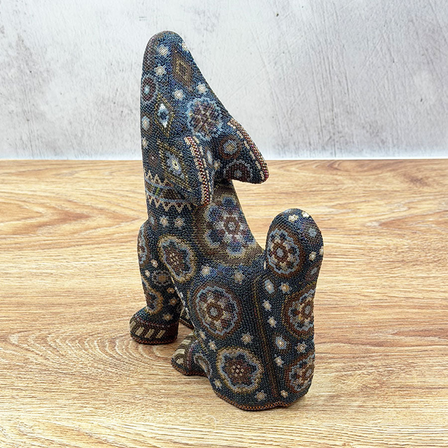Black howling coyote with Huichol design
