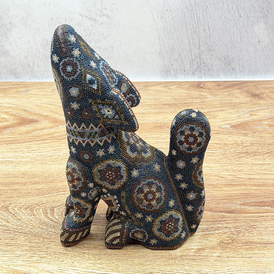 Black howling coyote with Huichol design