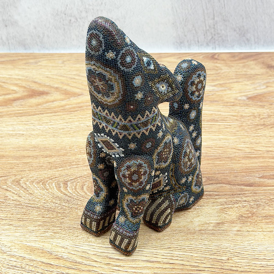Black howling coyote with Huichol design