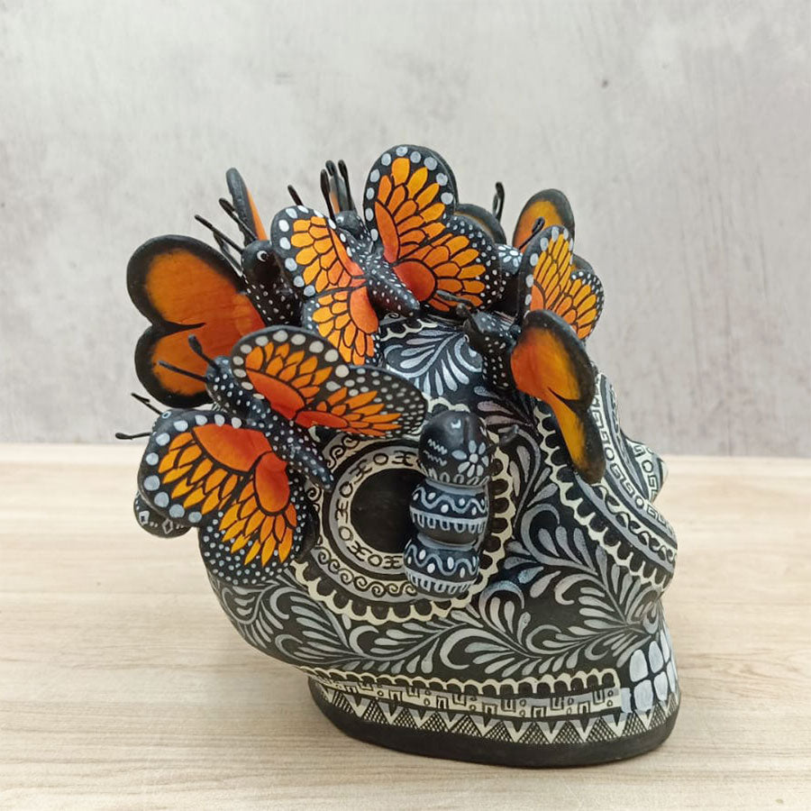 Black and white skull with monarch butterflies