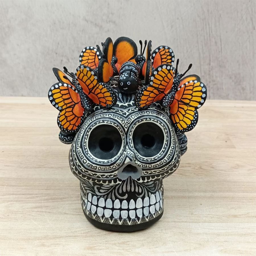 Black and white skull with monarch butterflies
