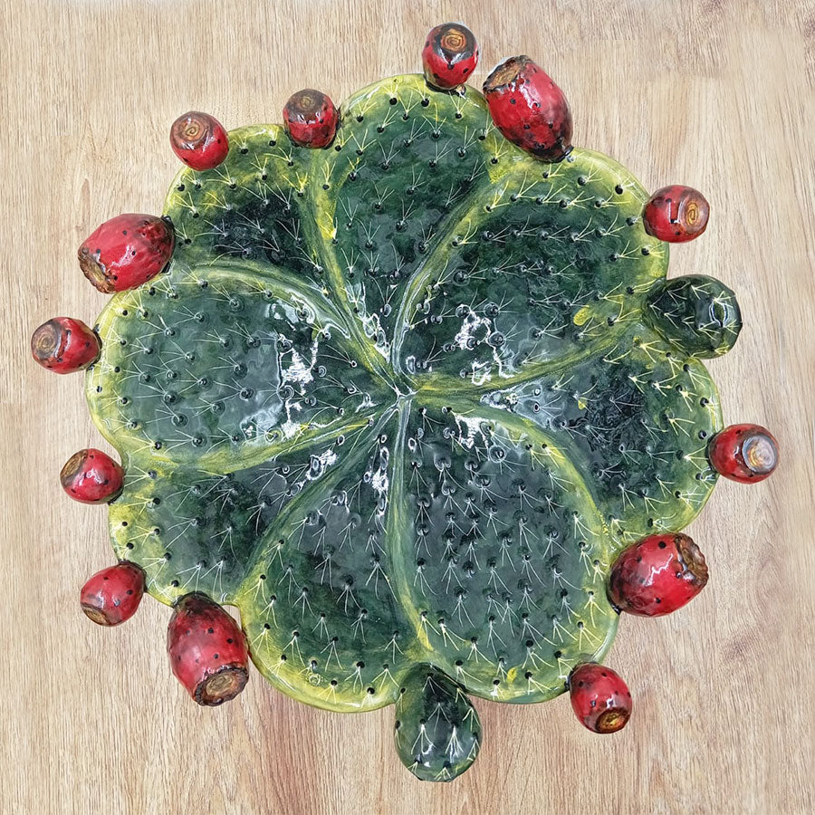 Salad bowl featuring a design of prickly pear pads and fruit.
