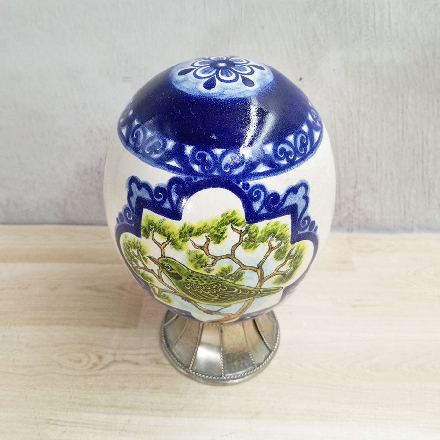 Egg-shaped figure decorated with bird