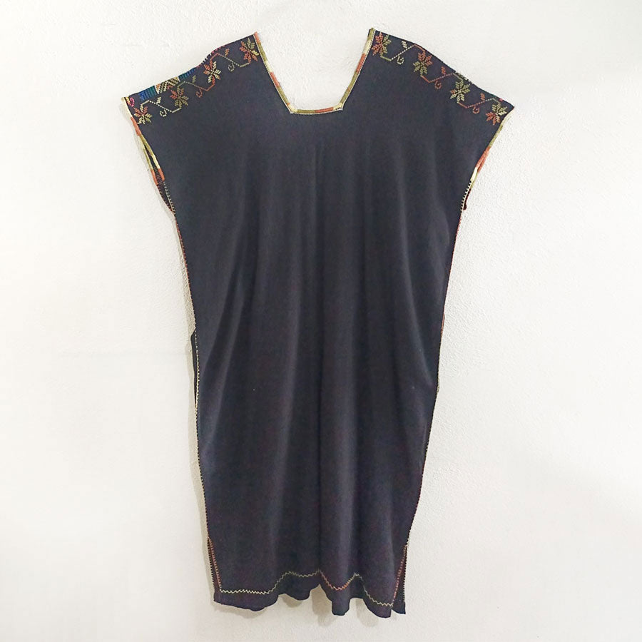 Black huipil with colorful embroidered stripe