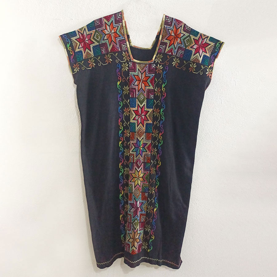 Black huipil with colorful embroidered stripe