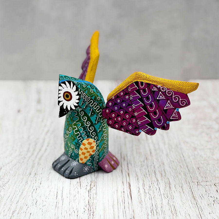 Green alebrije owl with purple wings