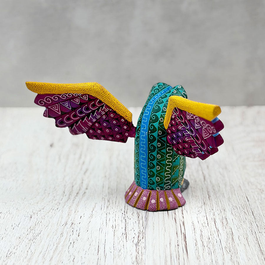 Green alebrije owl with purple wings