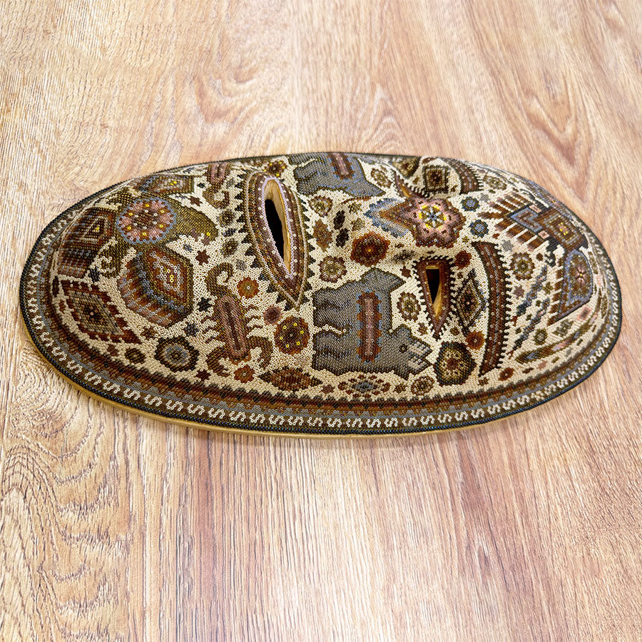 Blue mask with eagles in Huichol design