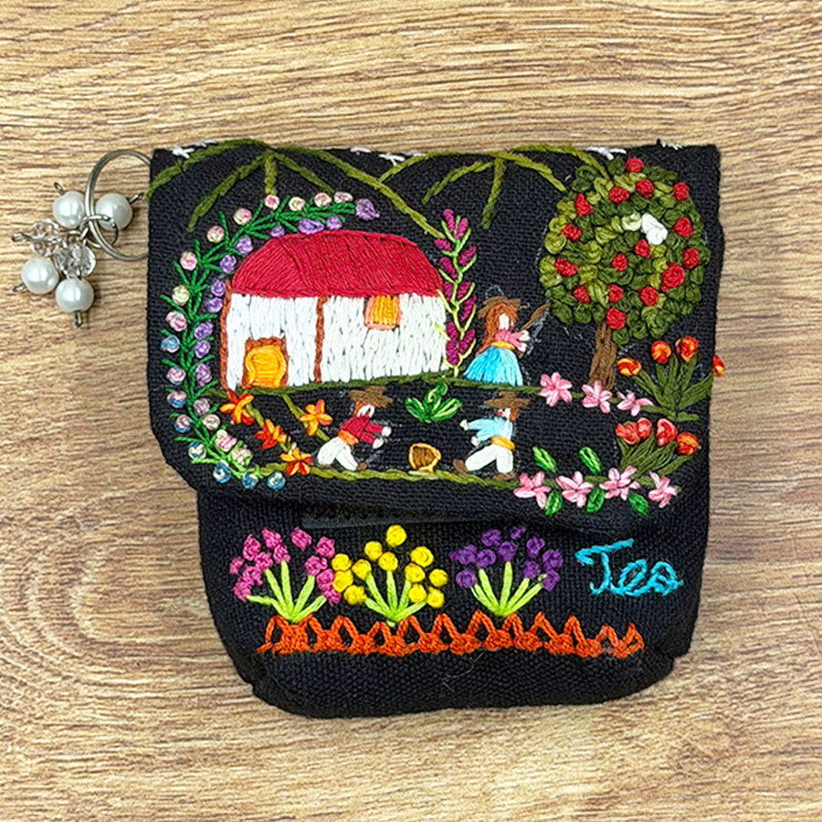 Black purse with embroidered Mexican scenes