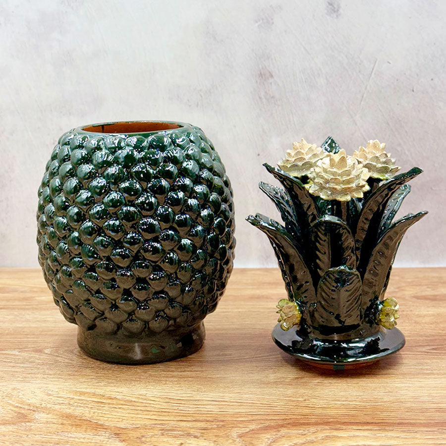 Green pineapple barrel design with white flowers made of glazed clay